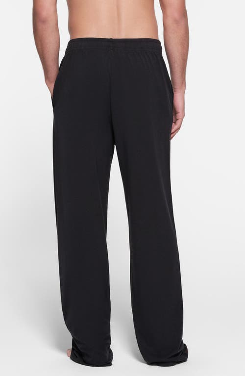 Shop Skims Straight Leg Stretch Lounge Pants In Obsidian