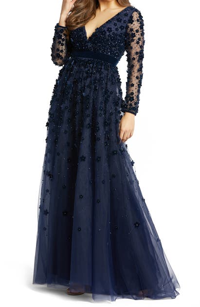 Click to view more detailed imagery on our partner's website Mac Duggal Velvet Floral Applique Long Sleeve Gown In Navy