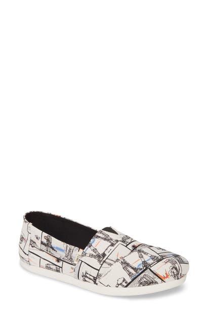 Click to view more detailed imagery on our partner's website Toms Alpargata Slip-On In White Star Wars Print Canvas