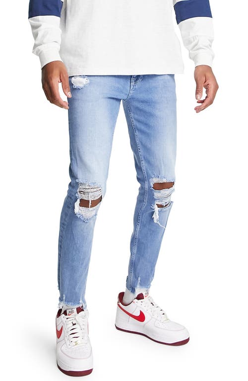 ASOS DESIGN Ripped Skinny Jeans in Medium Blue