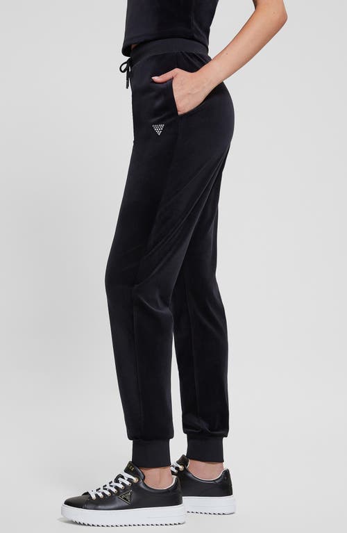 Shop Guess Couture Crystal Logo Embellished Velour Joggers In Jet Black