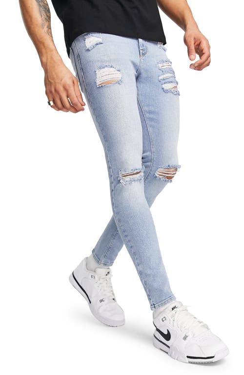 ASOS DESIGN Ripped Ultra Skinny Jeans in Mid Blue