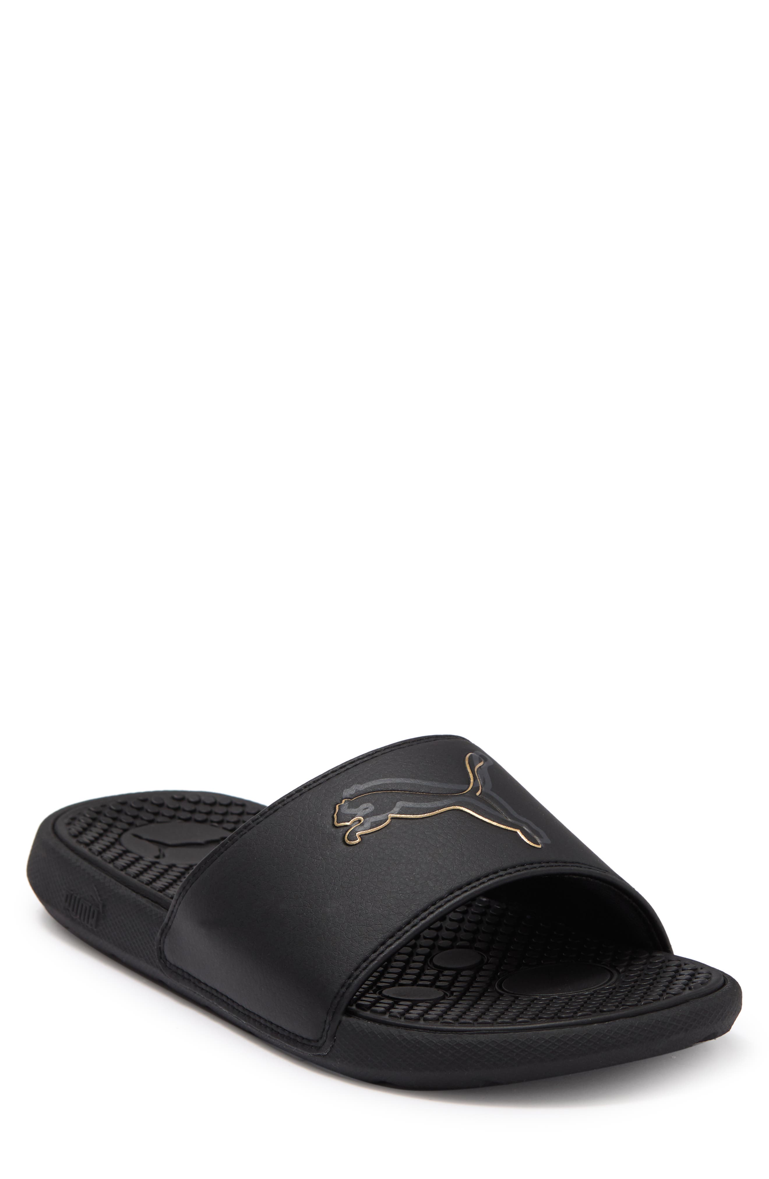 gold and black puma slides