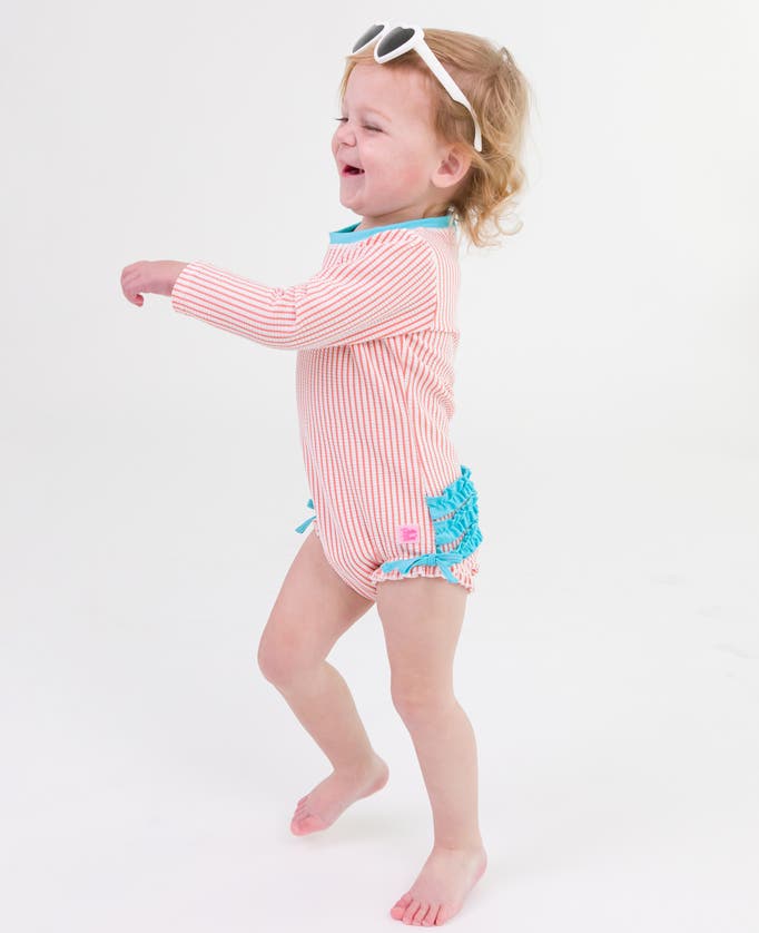 Shop Rufflebutts Girls Seersucker Long Sleeve Upf50+ One Piece Rash Guard In Coral