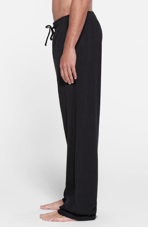 Shop Skims Straight Leg Stretch Lounge Pants In Obsidian