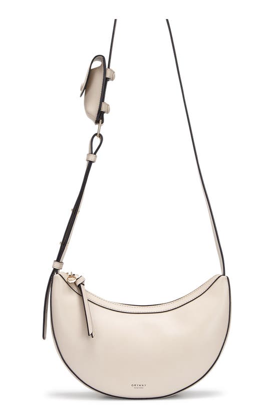 Shop Oryany Rookie Crescent Crossbody Bag In Cream