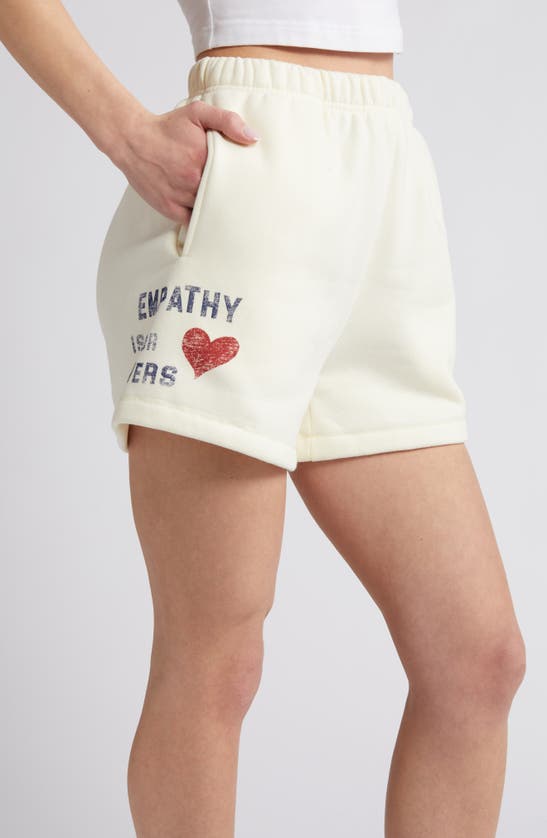 Shop The Mayfair Group Empathy Is For Lovers Graphic Sweat Shorts In Cream