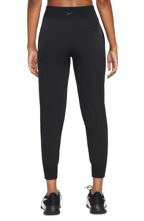 Shop Nike Dri-fit Bliss Mid-rise 7/8 Joggers In Black/clear