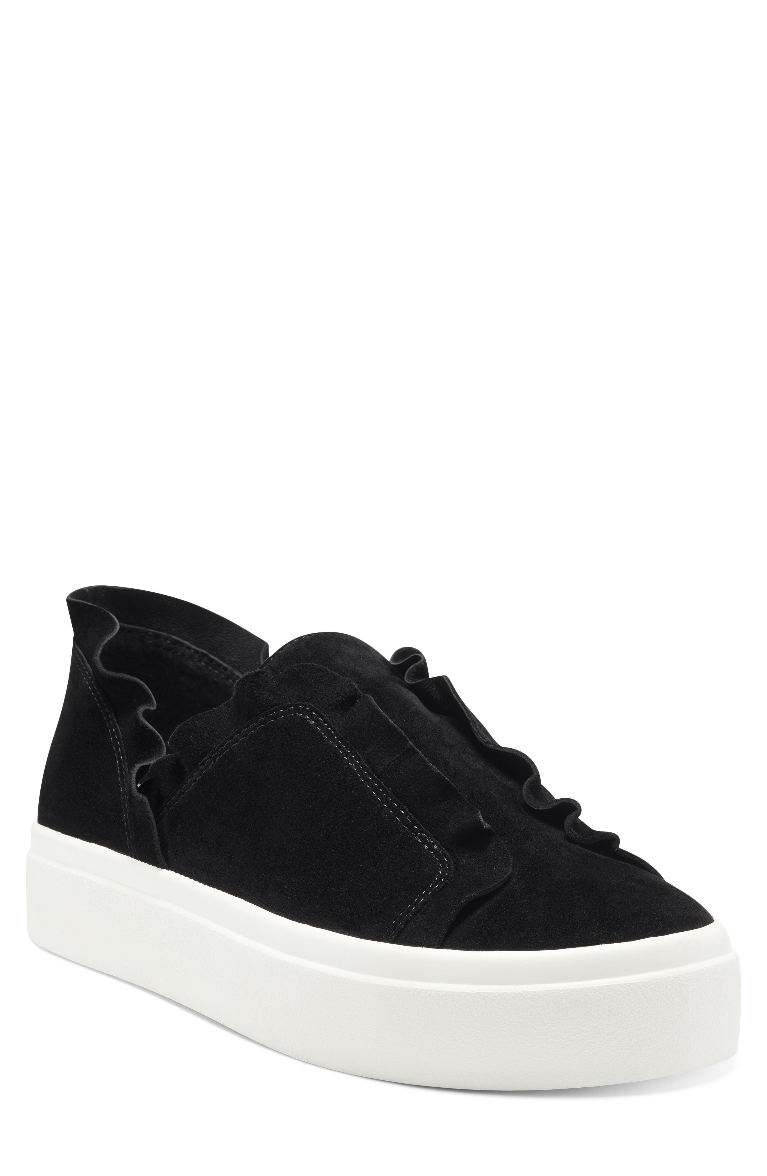 black slip on sneakers with black soles