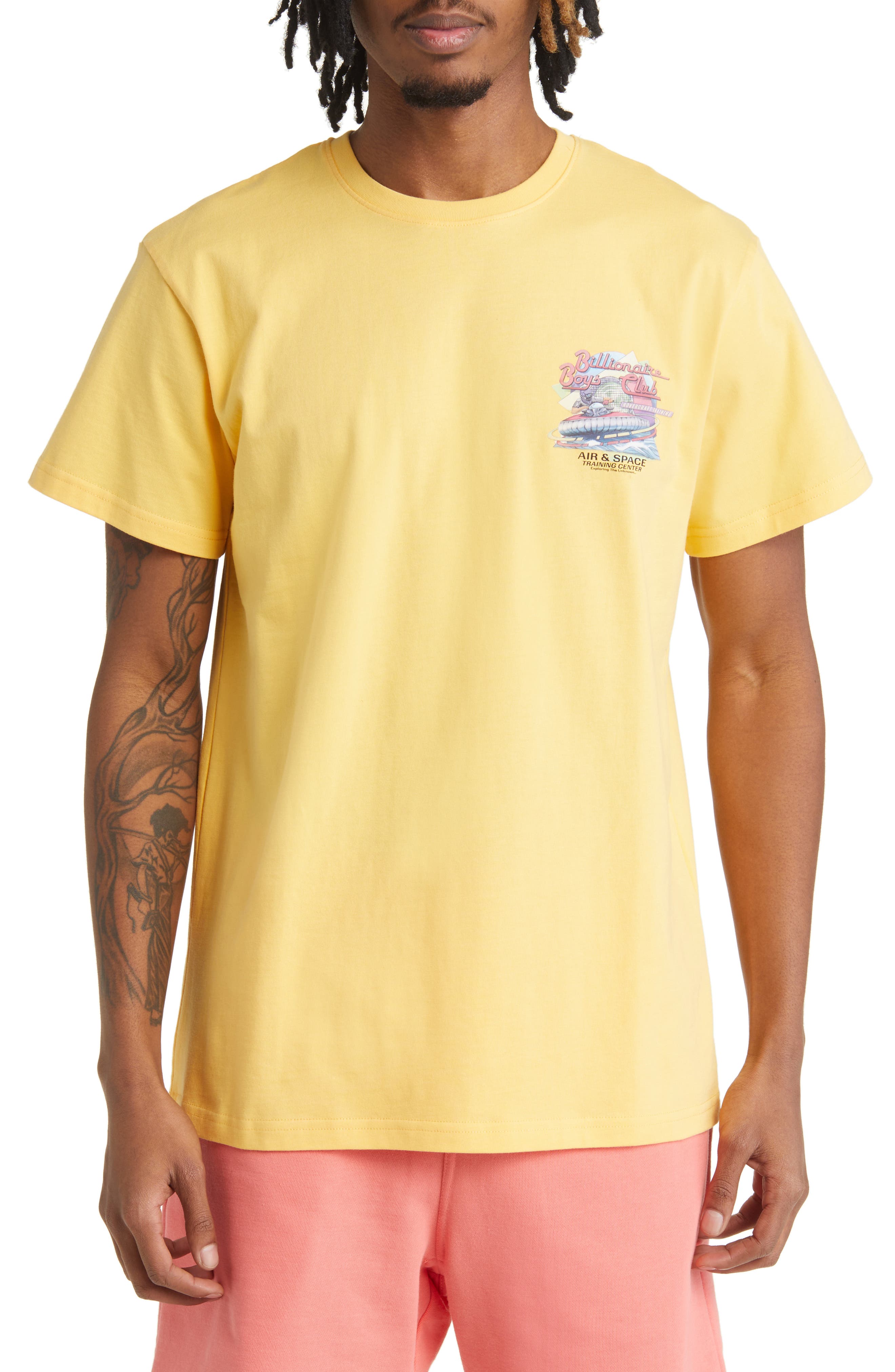 white and yellow graphic tee