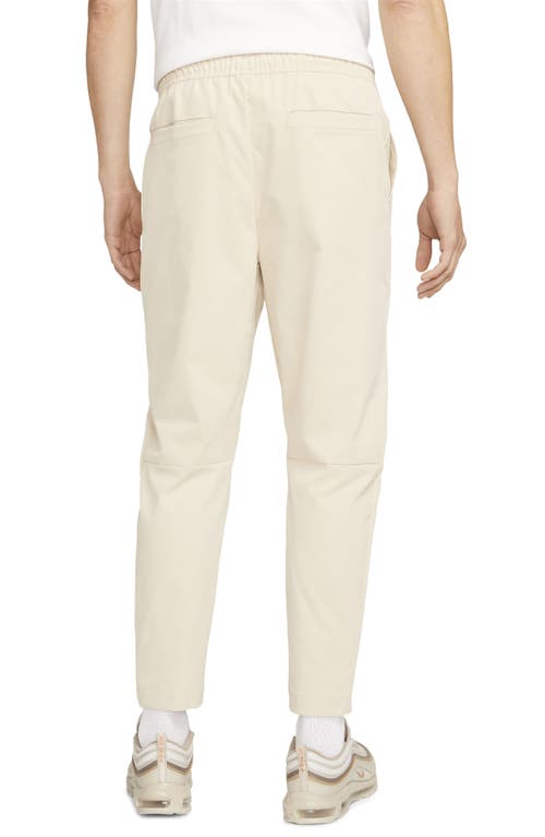 Shop Nike Woven Tapered Leg Pants In Sanddrift/white