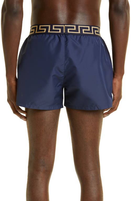 Shop Versace Greca Band Swim Trunks In Blu/gold