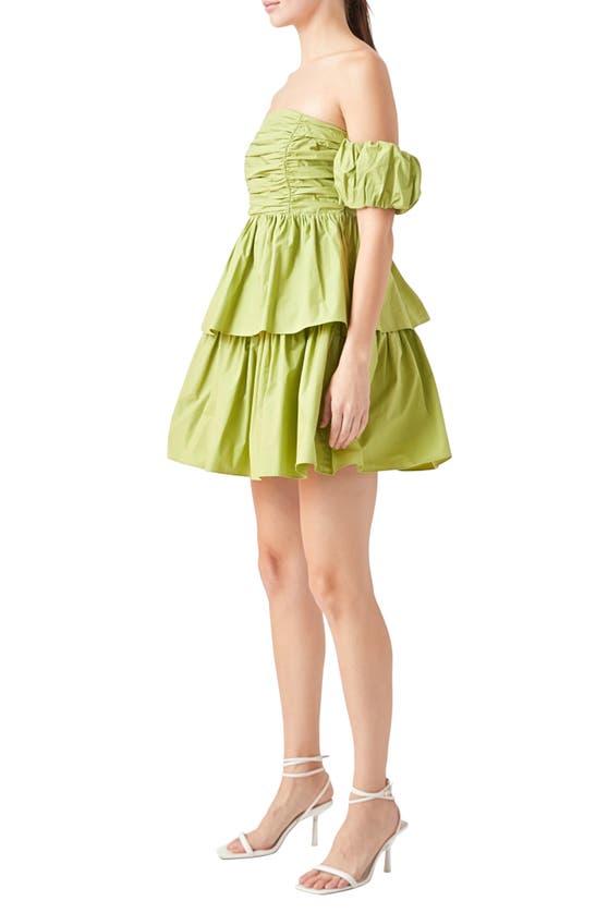 Shop Endless Rose Ruched Tiered Off The Shoulder Minidress In Pistachio