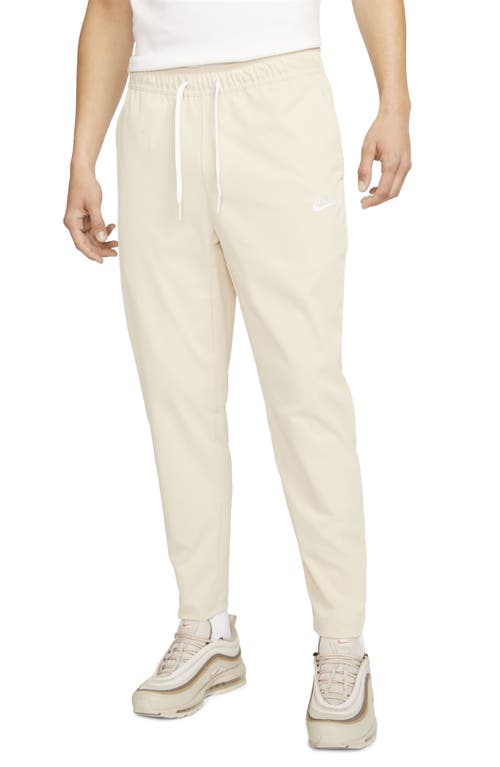 Shop Nike Woven Tapered Leg Pants In Sanddrift/white