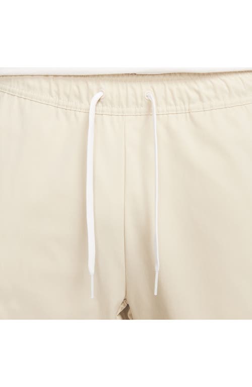 Shop Nike Woven Tapered Leg Pants In Sanddrift/white