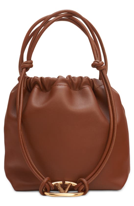 Shop Valentino Garavani Medium Vlogo Leather Drawstring Bag In N58 Tobacco