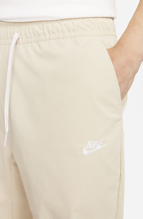 Shop Nike Woven Tapered Leg Pants In Sanddrift/white