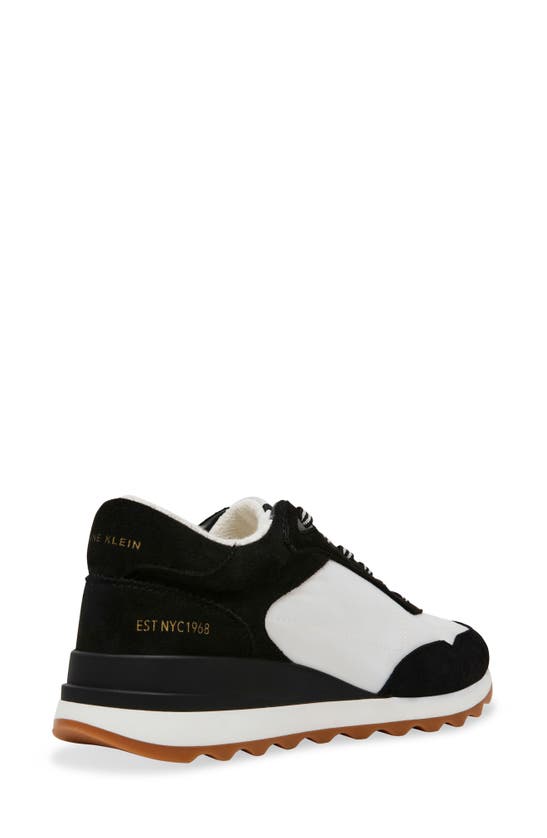 Shop Anne Klein Restless Wedge Sneaker In Black/ White