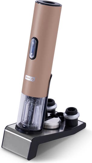 A rose gold electric wine opener on a black base