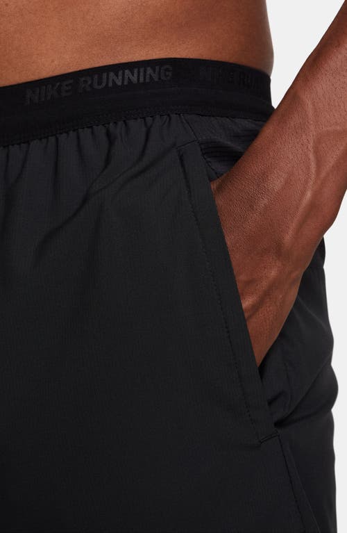 Shop Nike Dri-fit Stride 2-in-1 Running Shorts In Black/black/silver