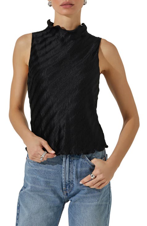 Woman wearing black V-neck sleeveless top and distressed blue