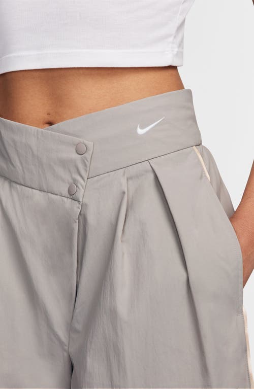 Shop Nike Asymmetric Waist Water Repellent Pants In Light Iron Ore/brown/white