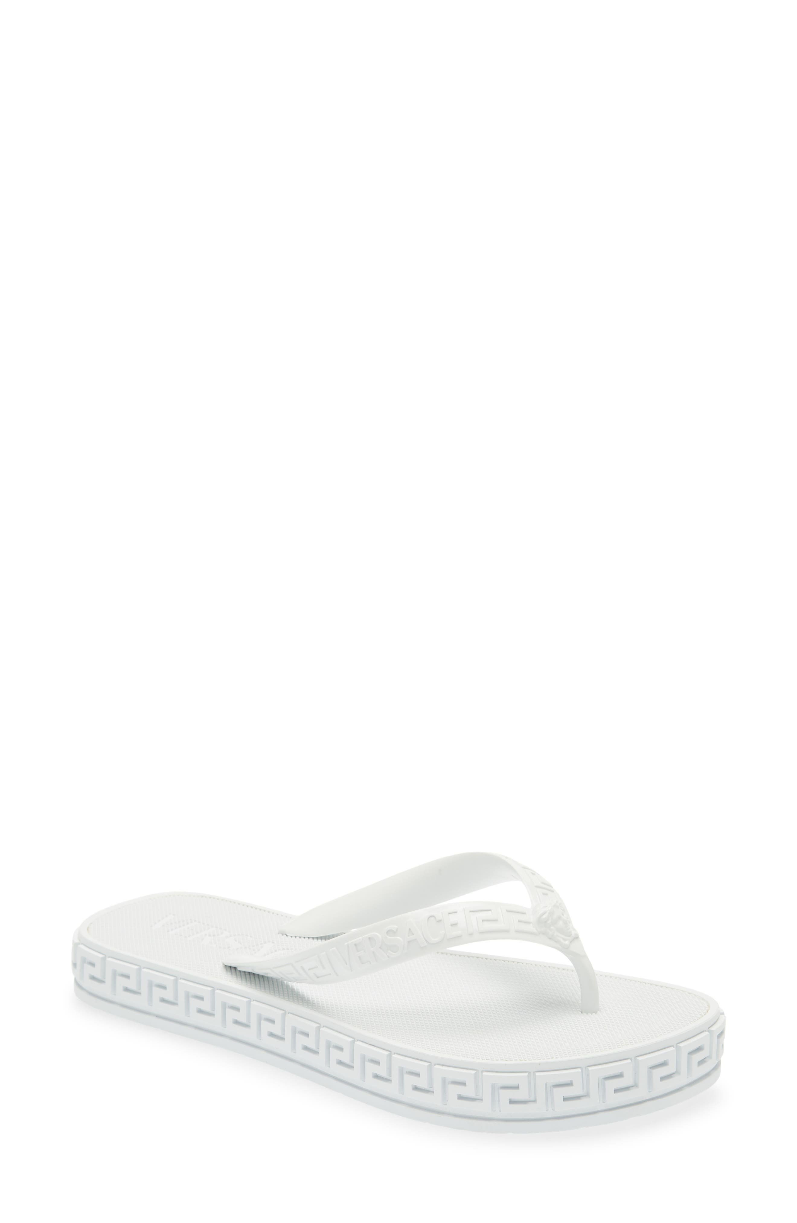 white designer flip flops