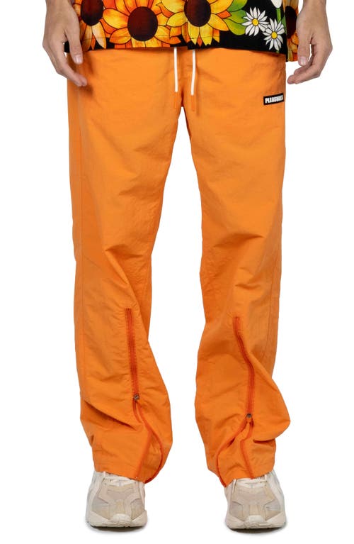 PLEASURES Gaze Track Pants in Orange