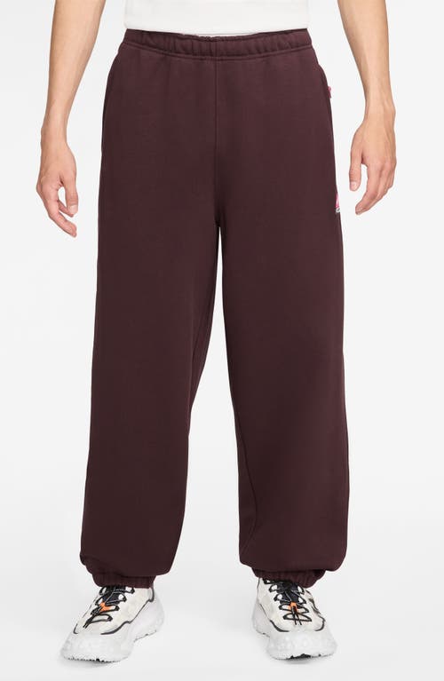 Shop Nike Acg Lungs Therma-fit Repel Tuff Fleece Pants In Burgundy Crush/laser Fuchsia