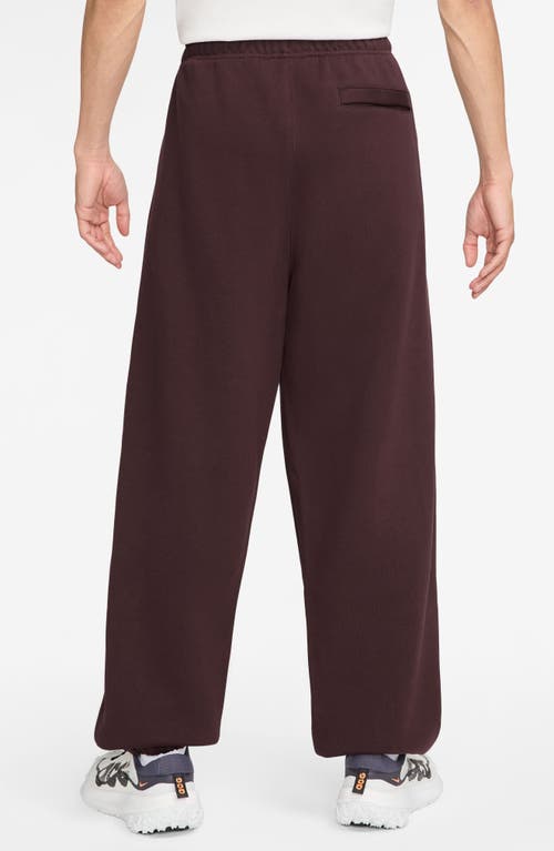 Shop Nike Acg Lungs Therma-fit Repel Tuff Fleece Pants In Burgundy Crush/laser Fuchsia