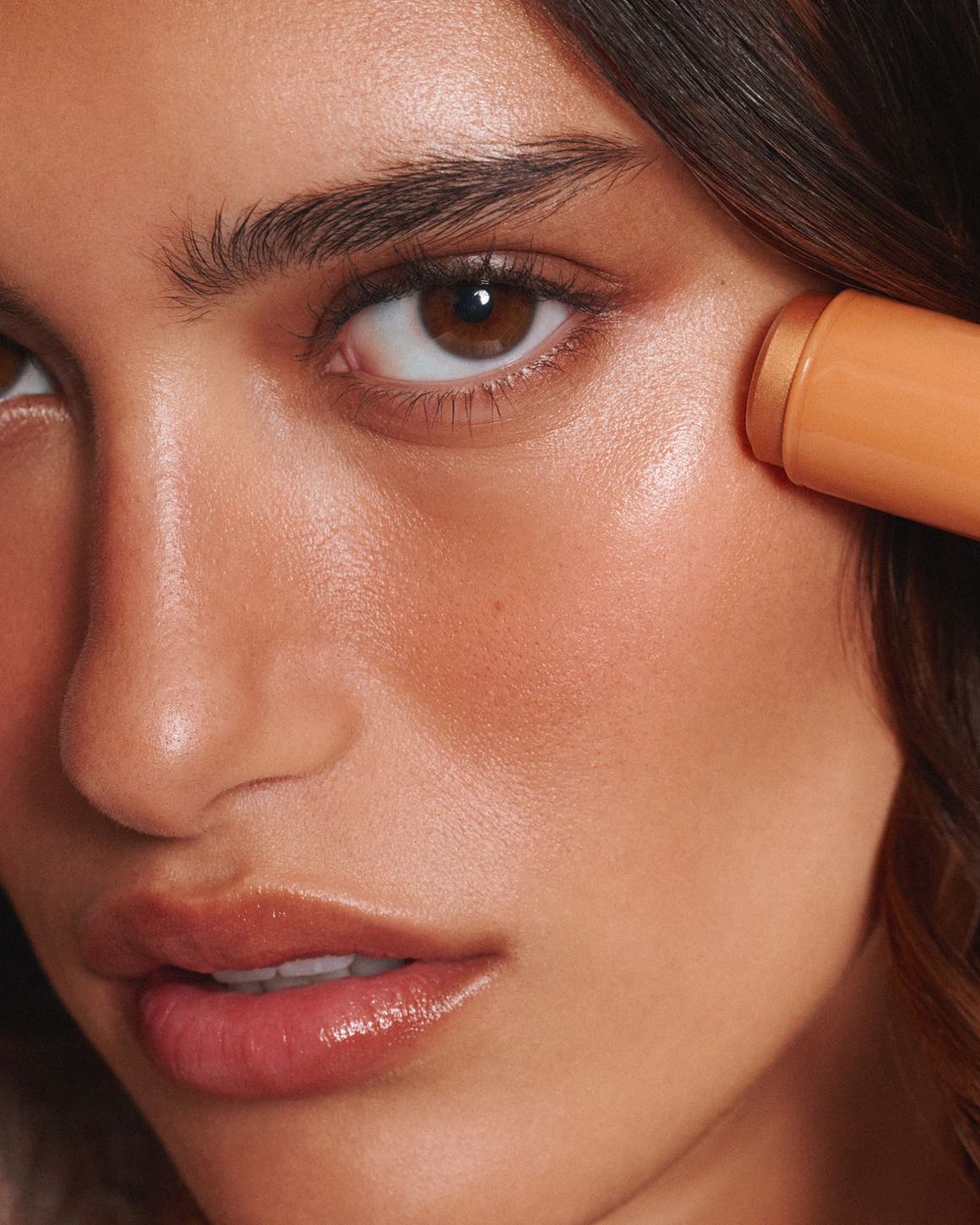 A woman applying bronzer.