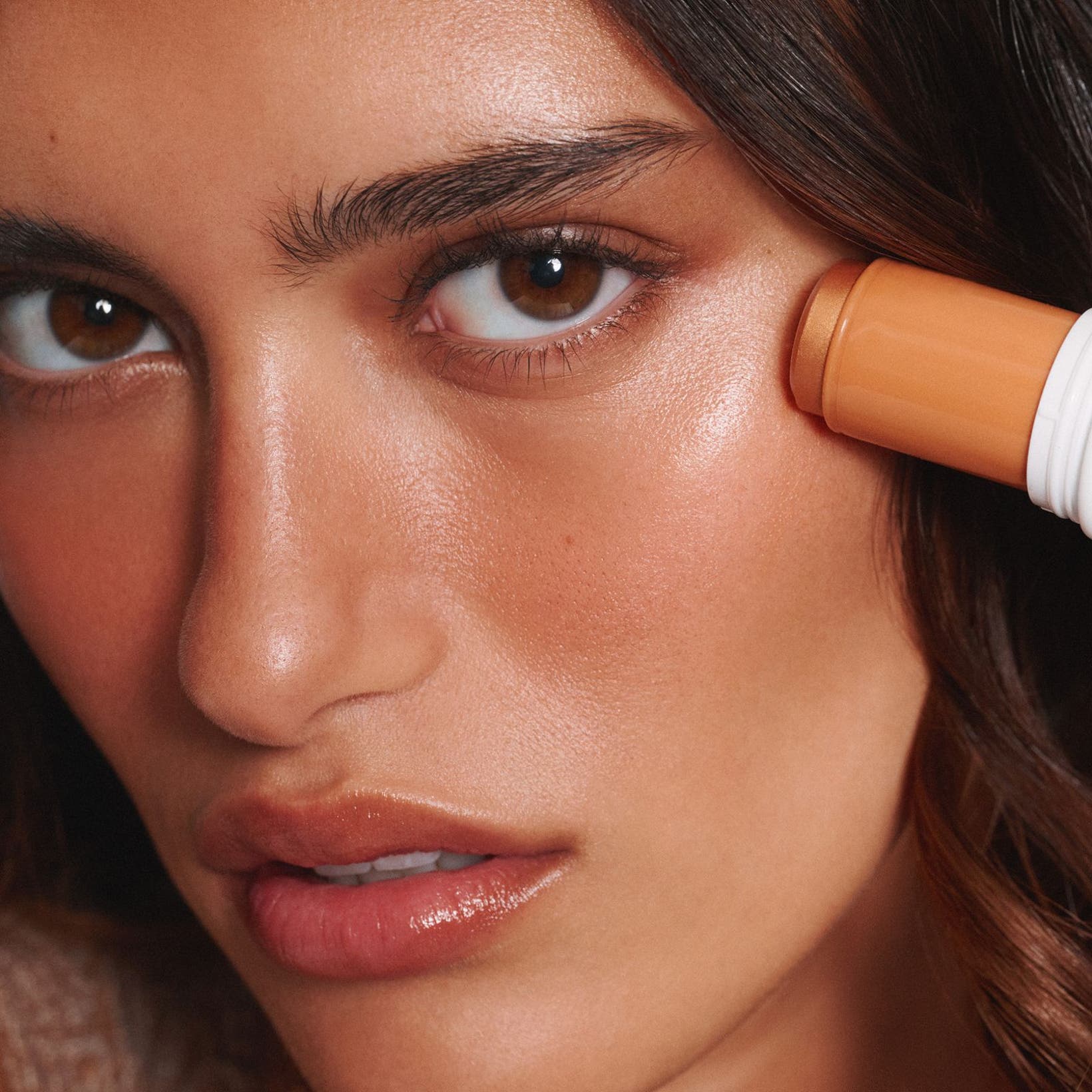 A woman applying bronzer.