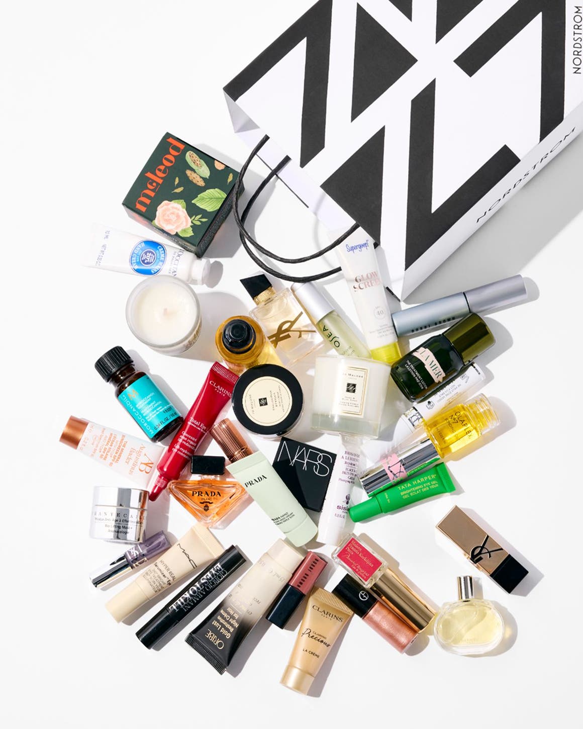 Assorted beauty products and a Nordstrom shopping bag.