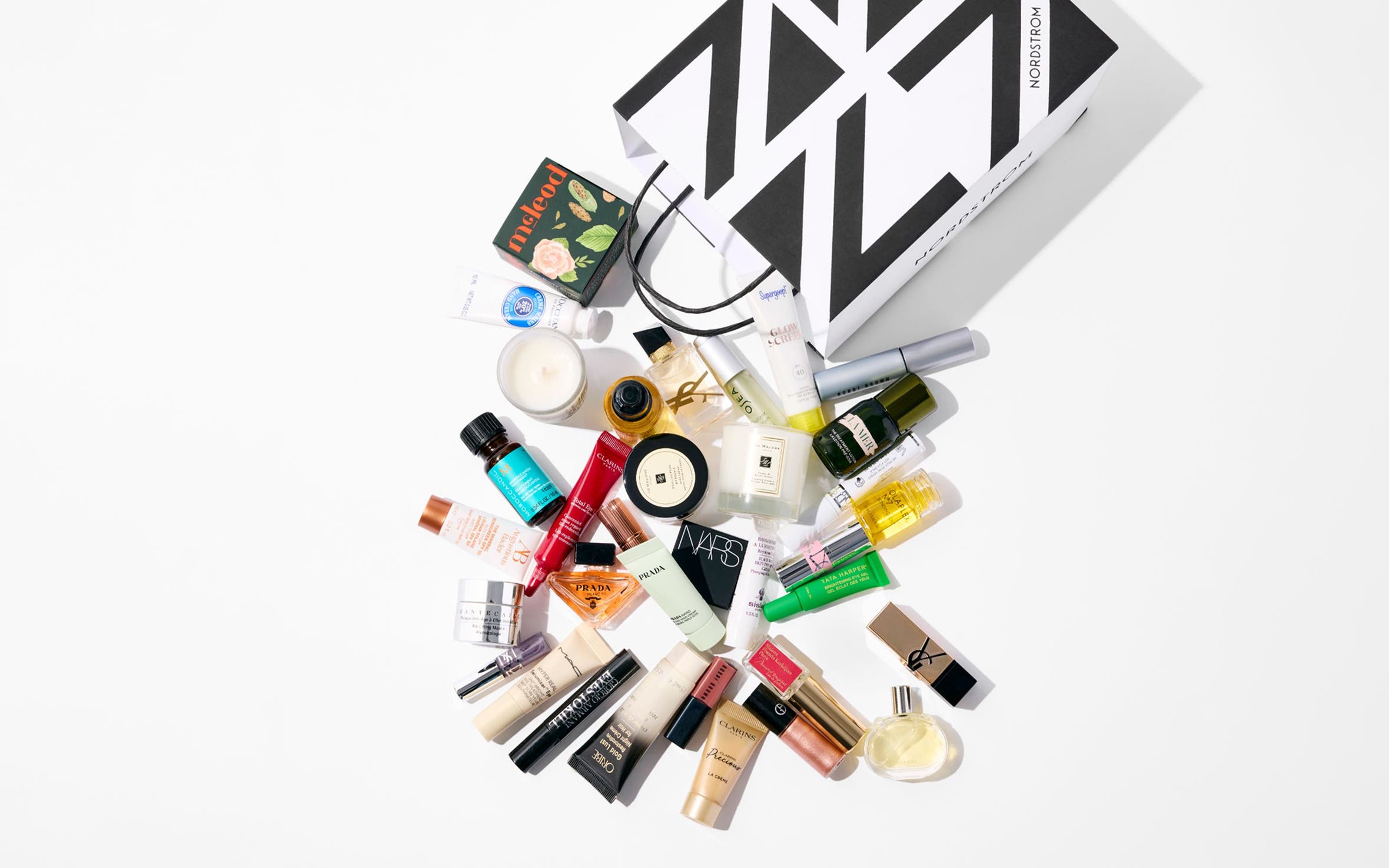 Assorted beauty products and a Nordstrom shopping bag.