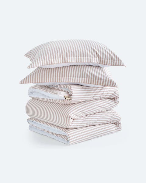 A pile of striped neutral bedding.