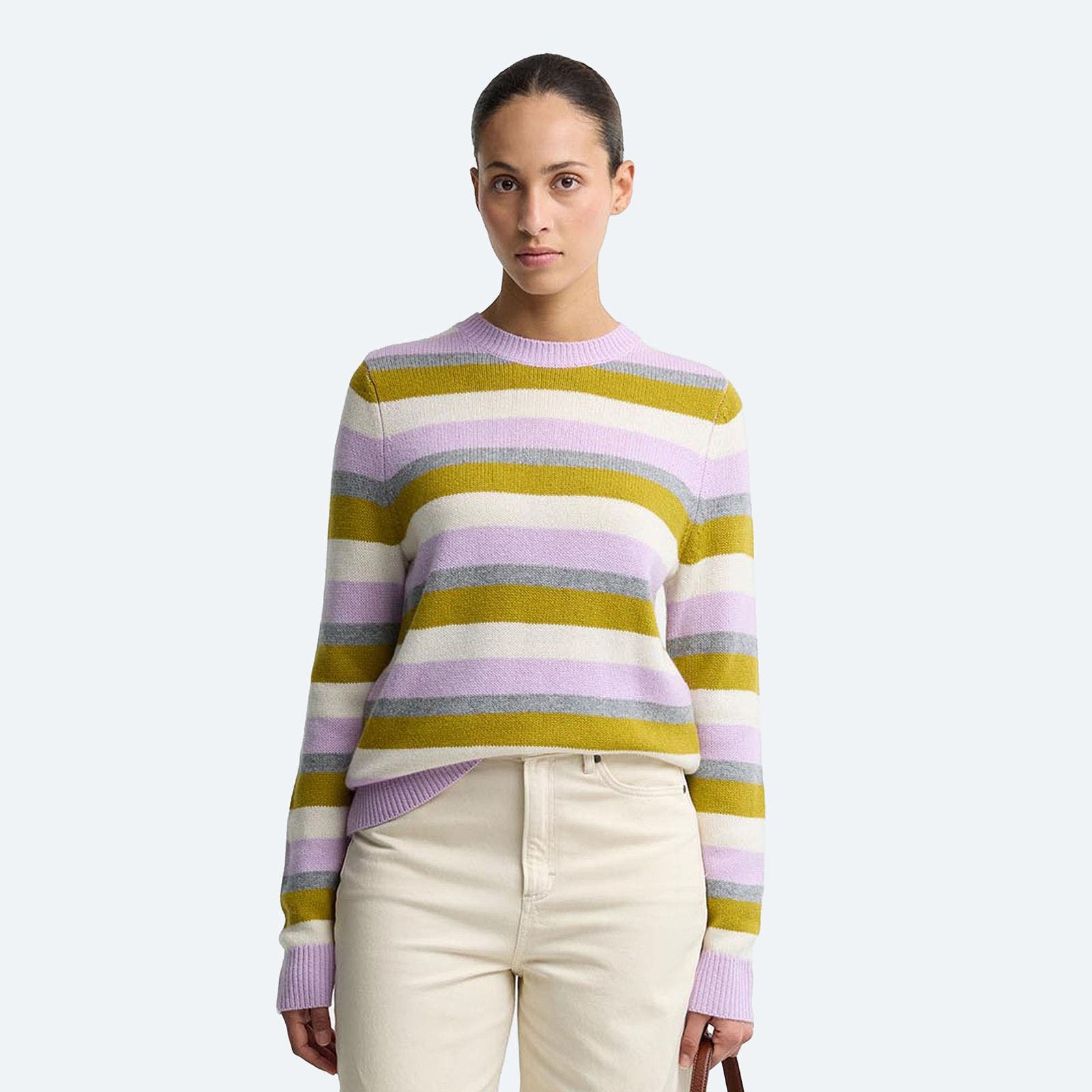 A woman in a lavender and olive striped sweater.