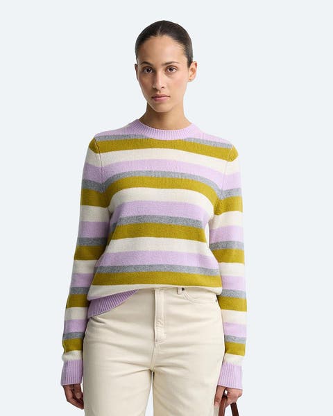 A woman in a lavender and olive striped sweater.