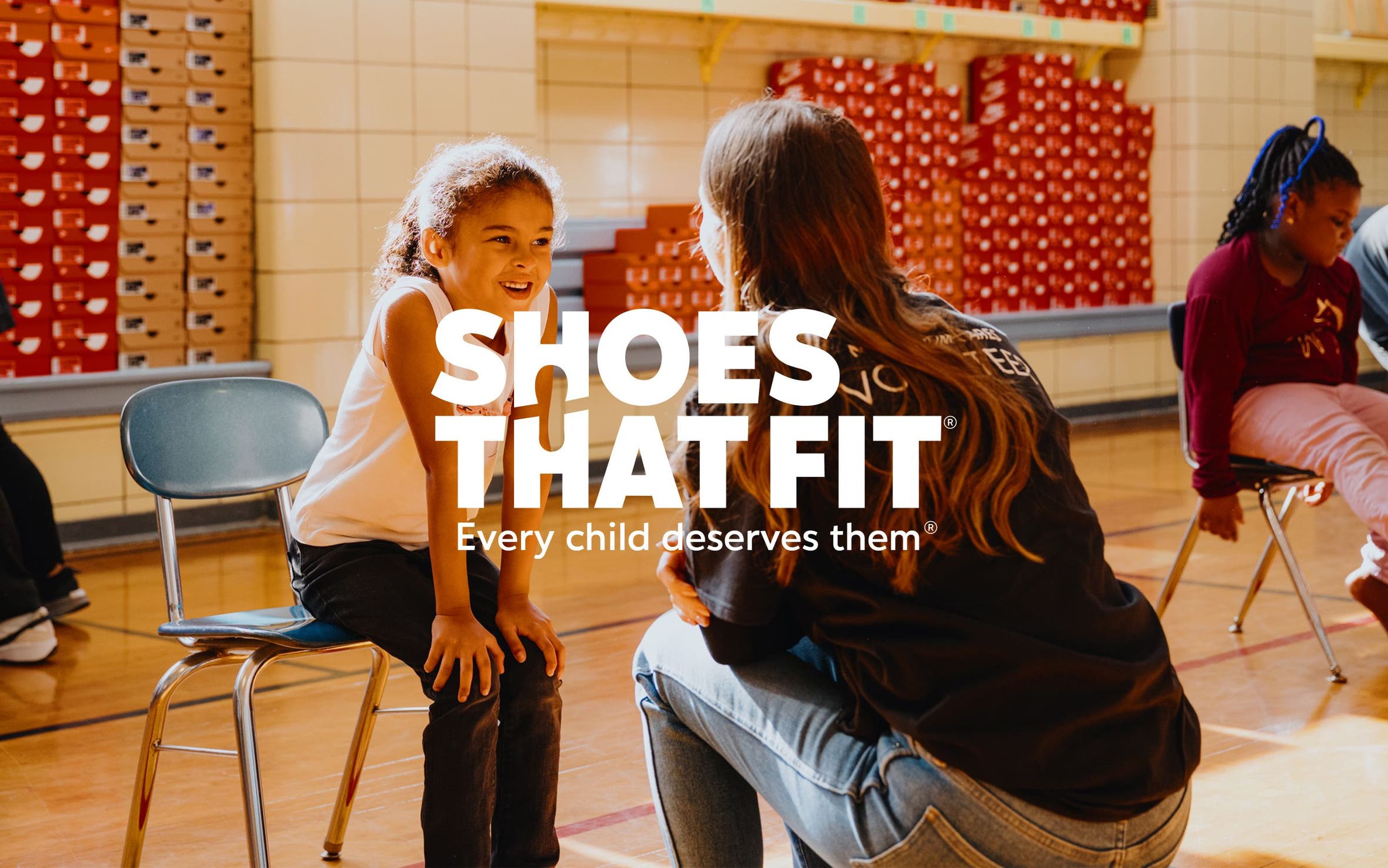 Shoes That Fit; a child trying on new shoes.