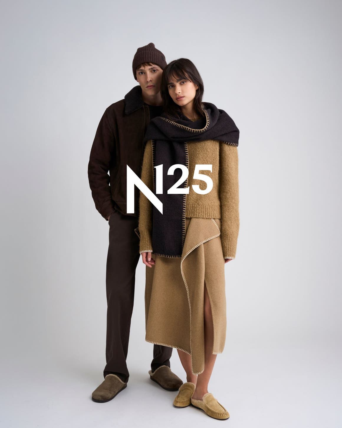 Two models in coordinated brown and camel cold-weather outfits with the white N25 logo overlaid