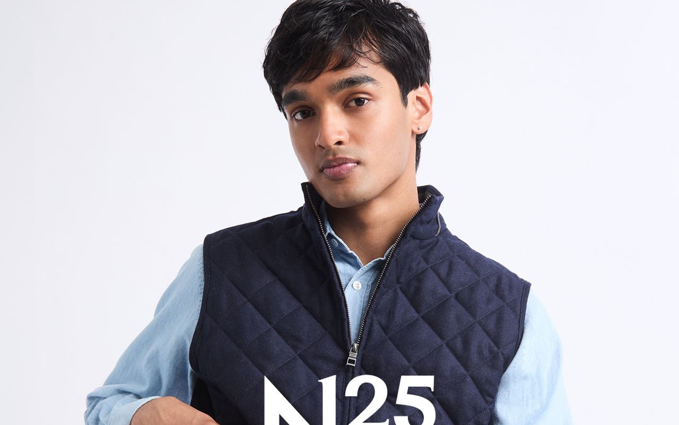 A man wearing Peter Millar vest.