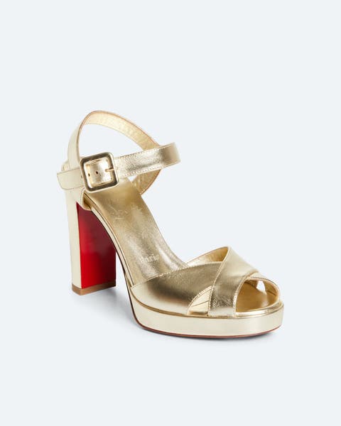 Gold heels by Christian Louboutin.