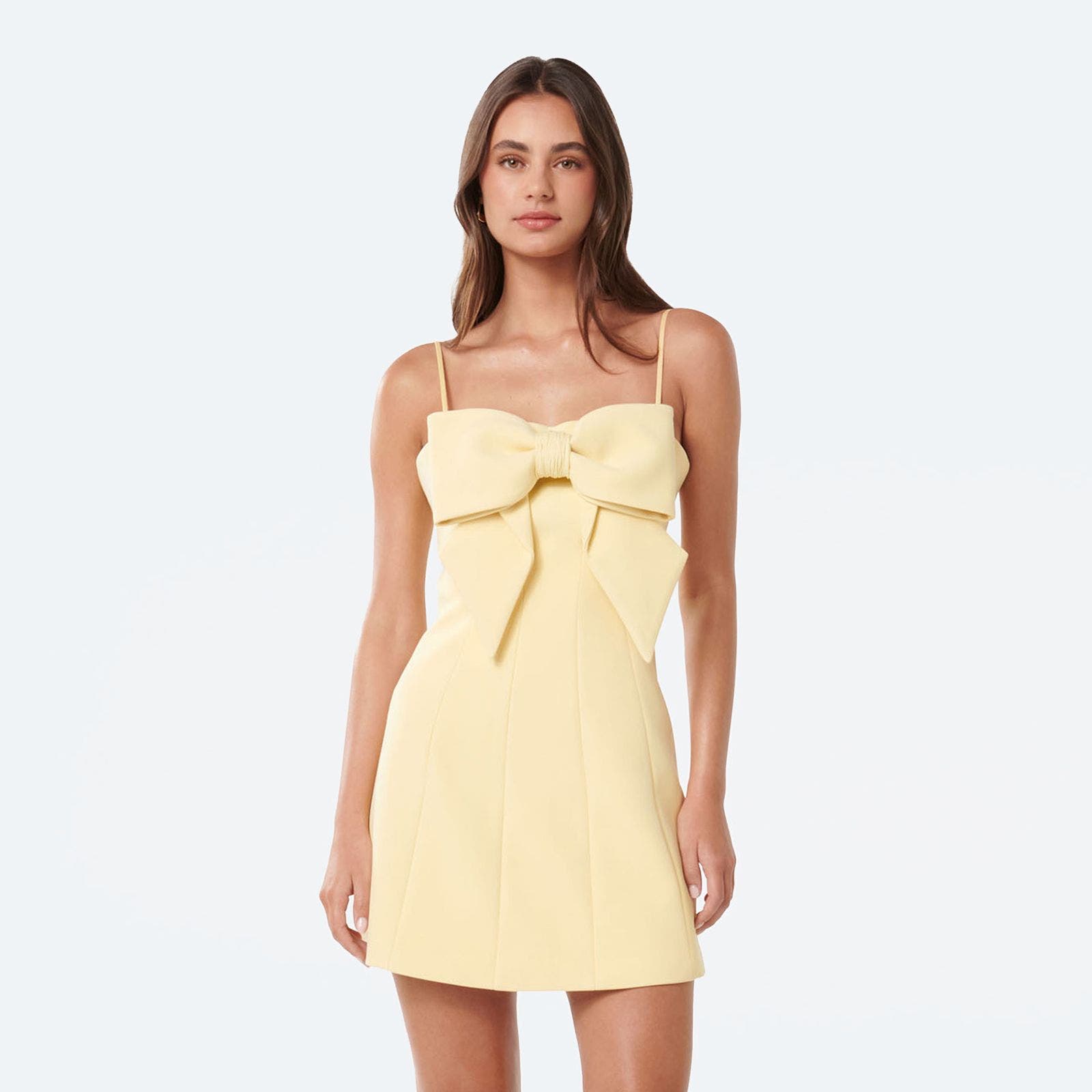 A woman wearing a semi-formal butter yellow mini dress.