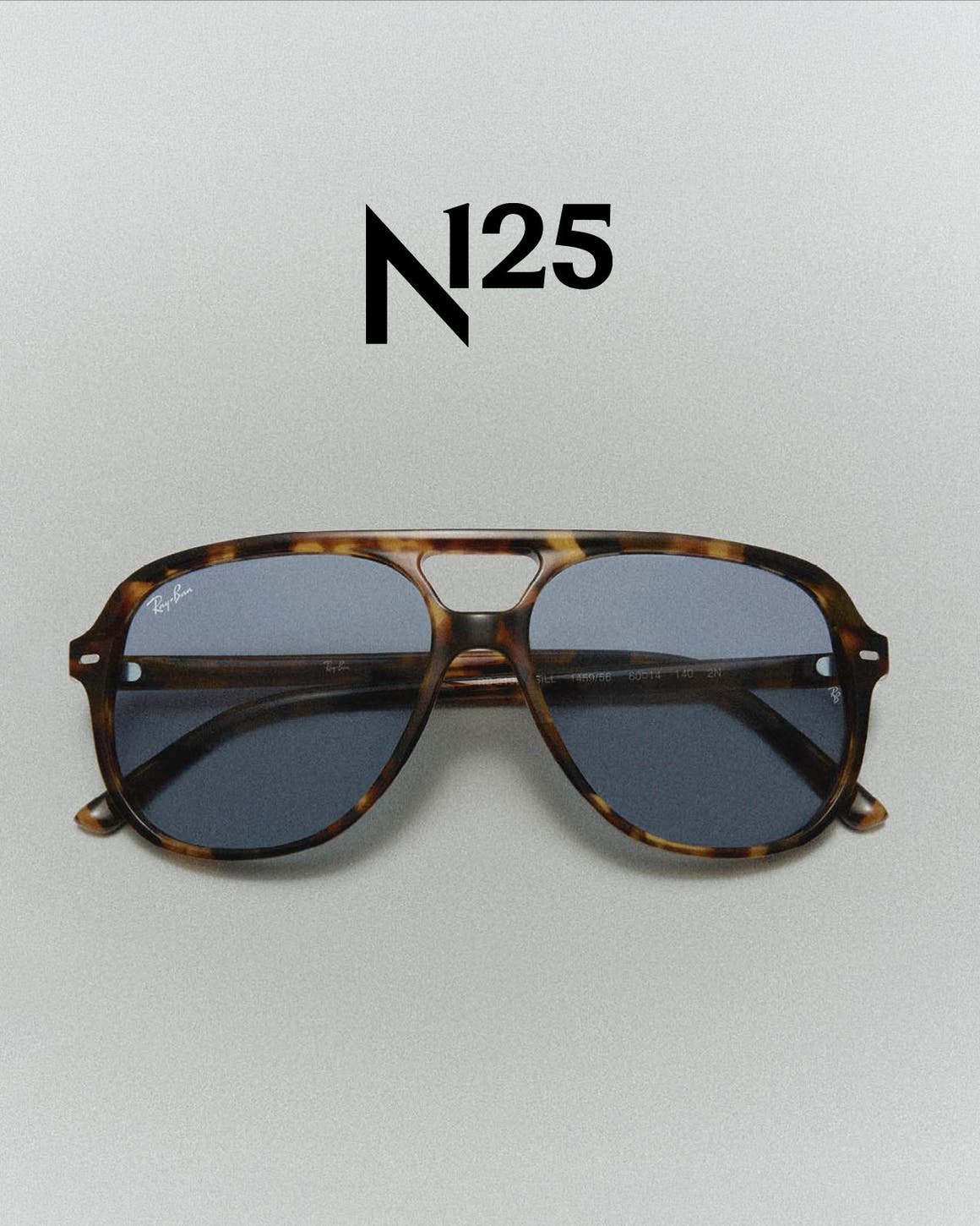 Classic tortoise-shell Ray-Ban sun glasses and the Ray-Ban logo.