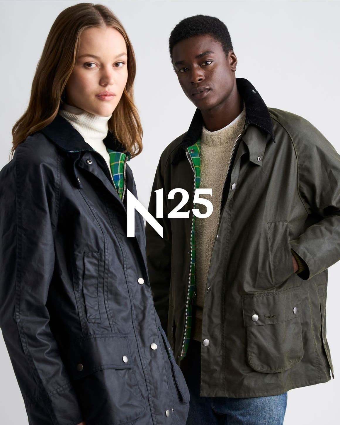 A woman and man in waxed field jackets, with an N125 logo overlay.