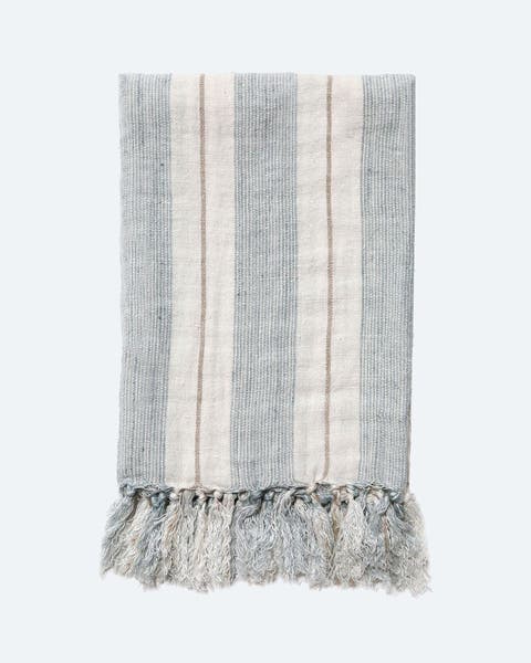 A striped linen blanket with tassels.