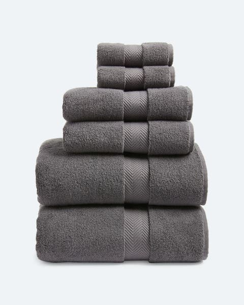 A stack of charcoal grey towels in various sizes.
