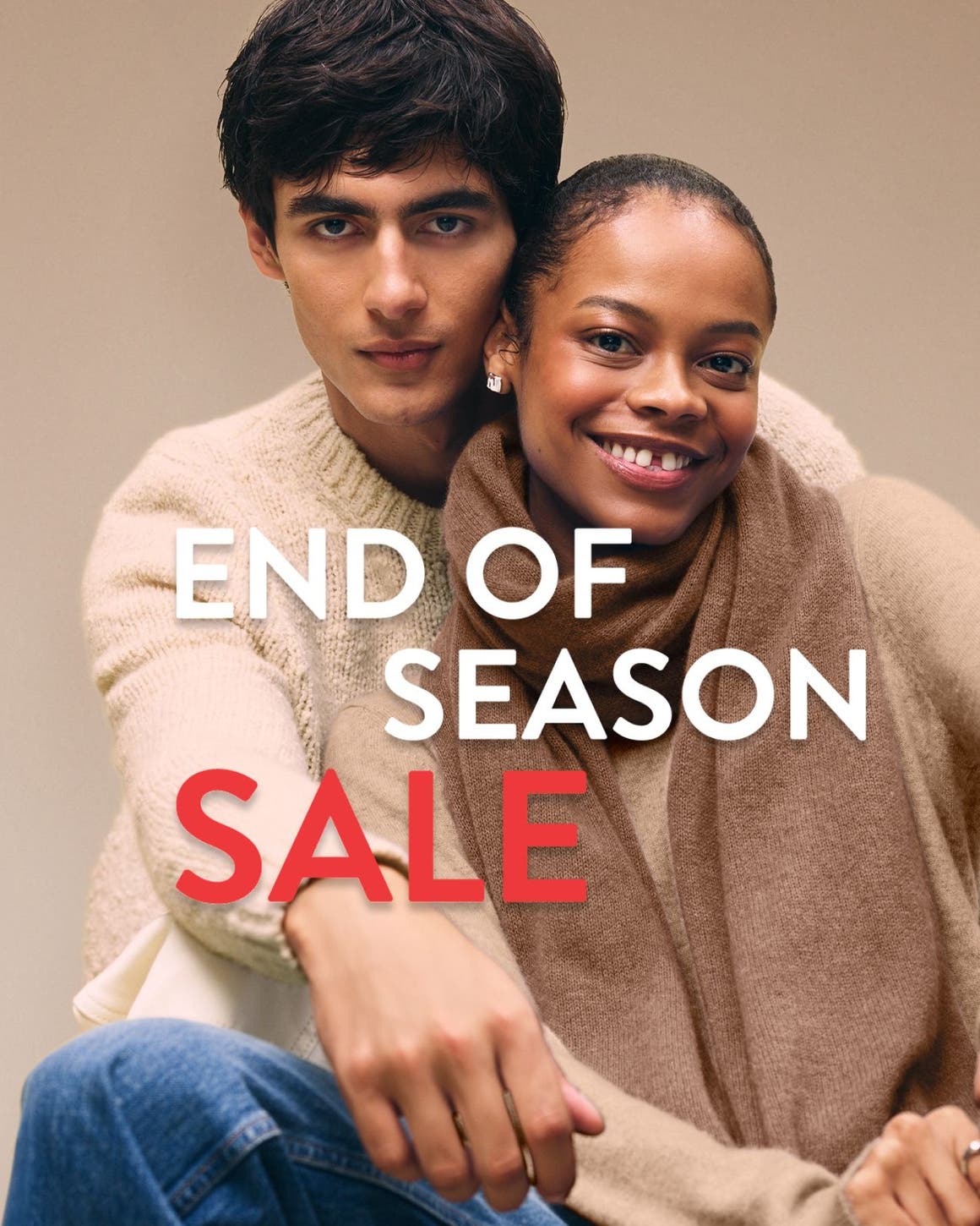 End-of-season sale. A woman and man wearing cozy knitwear.