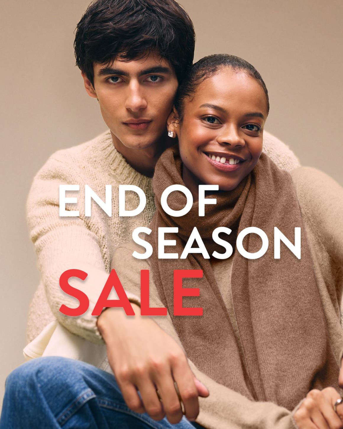 End-of-season sale. A woman and man wearing cozy knitwear.