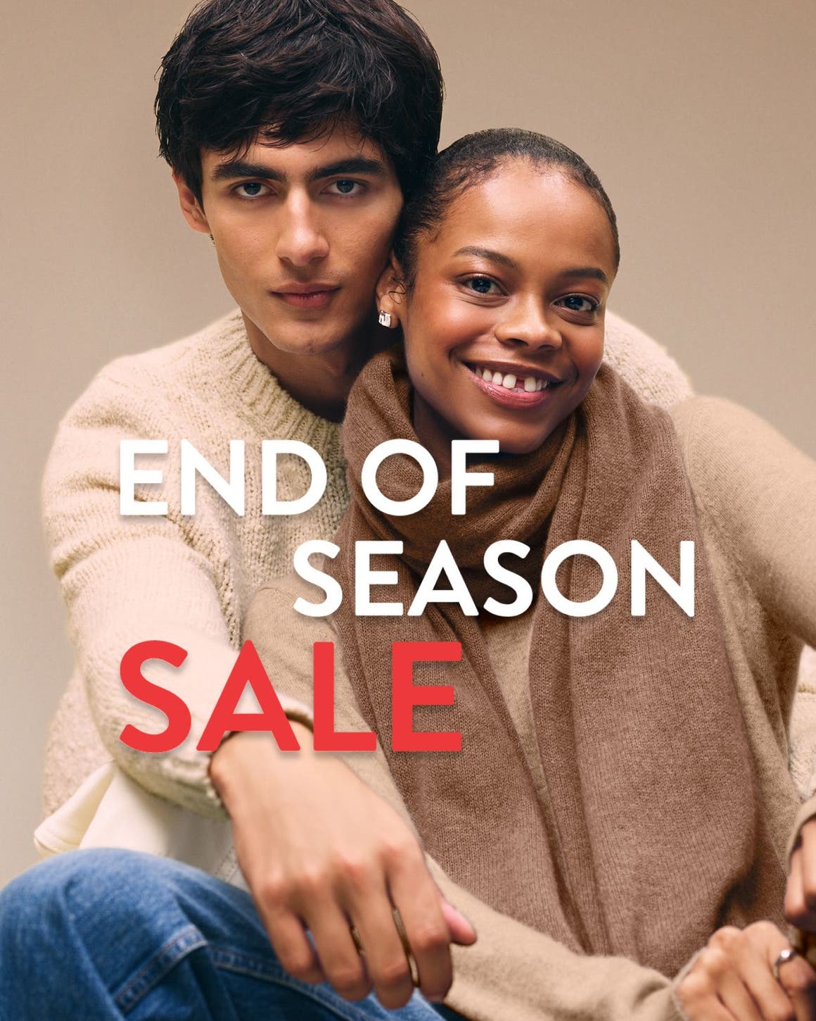 End-of-season sale. A woman and man wearing cozy knitwear.