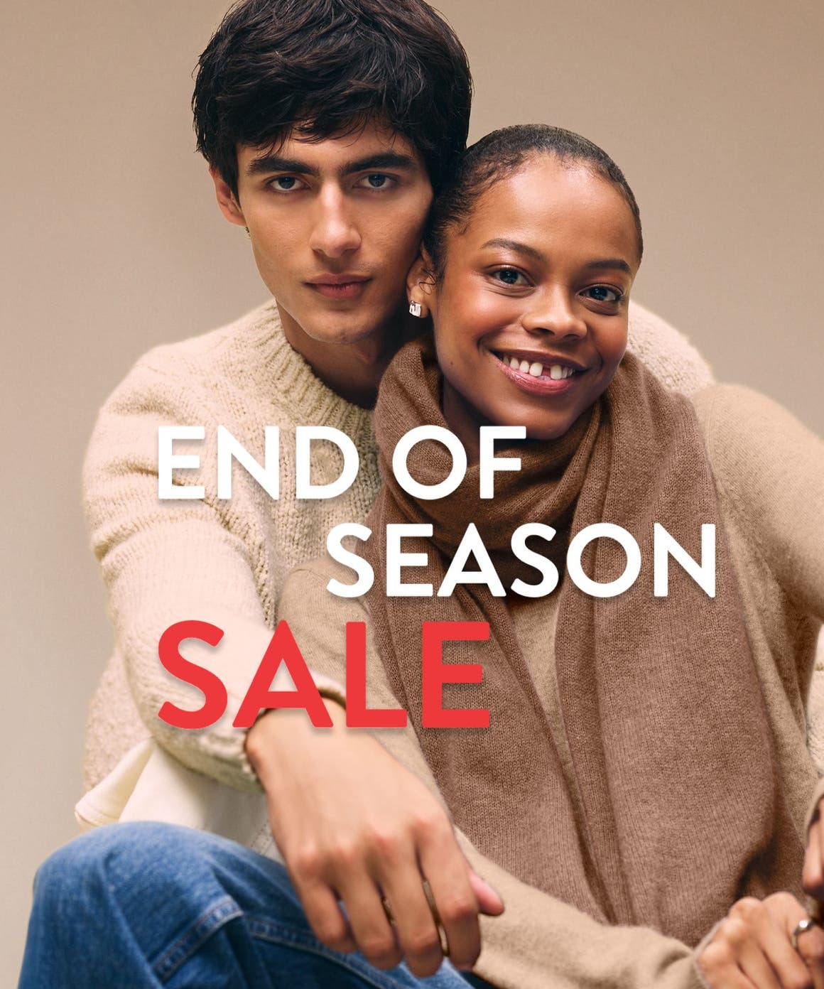 End-of-season sale. A woman and man wearing cozy knitwear.